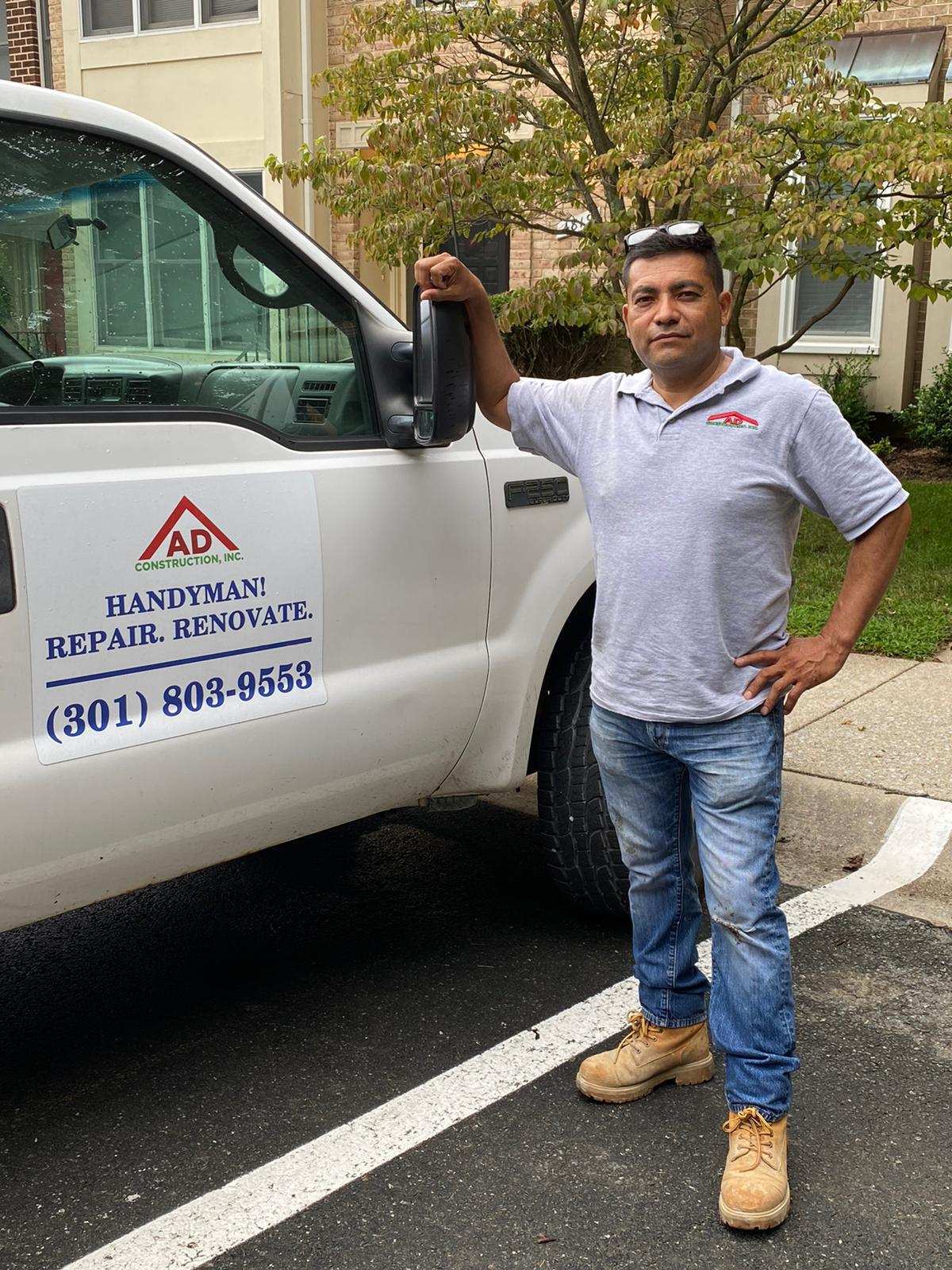 Diaz Construction owner standing beside company truck